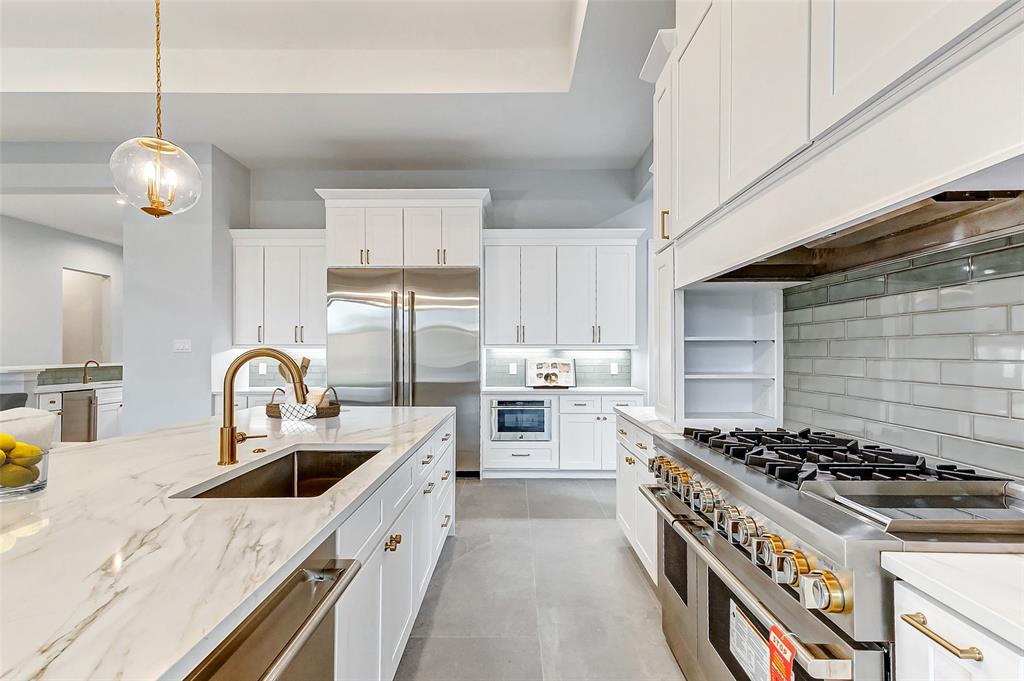Light-filled Maribelle kitchen with island, white cabinetry and pendant lighting